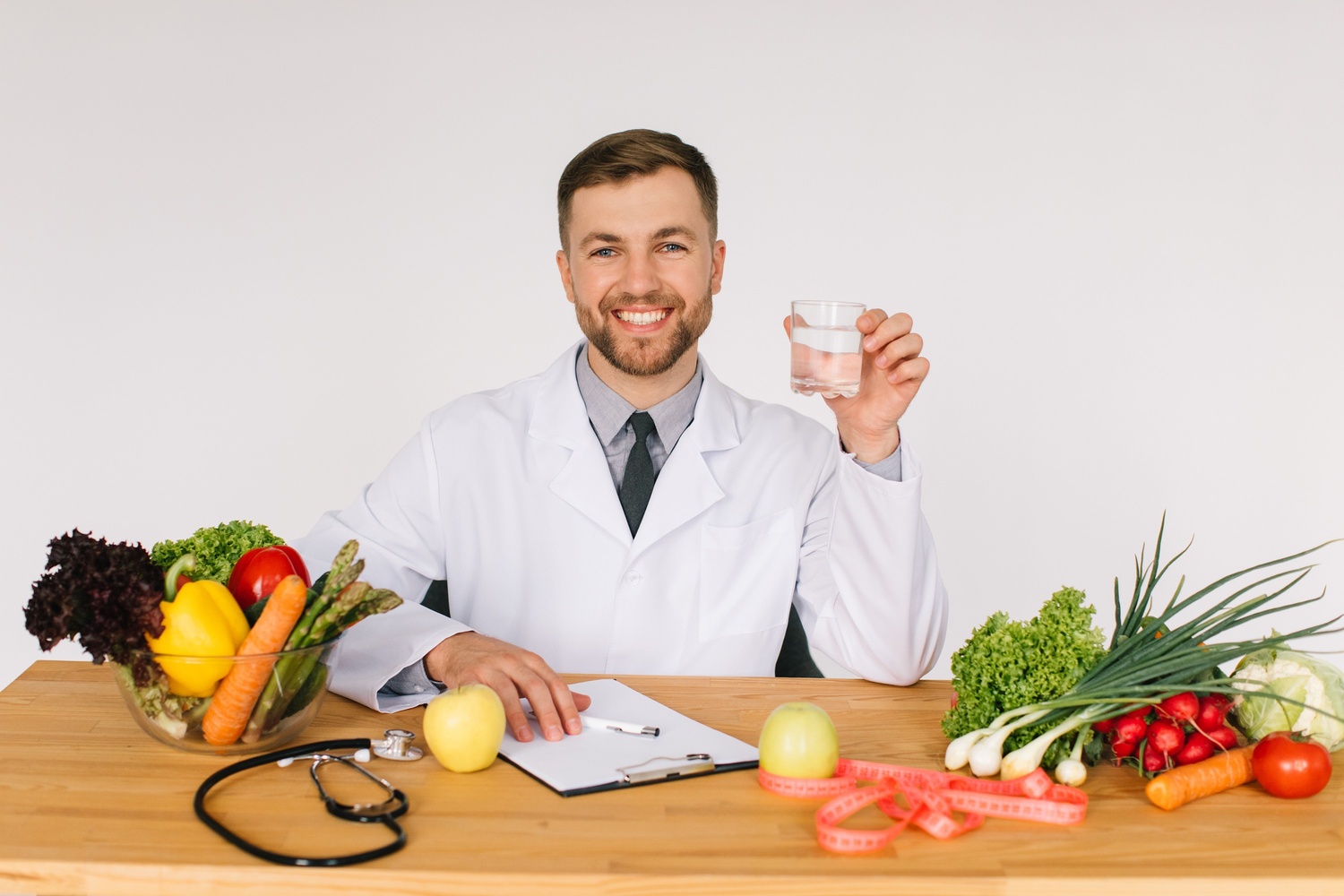 happy doctor nutritionist sitting at workplace at svzvda7.jpg